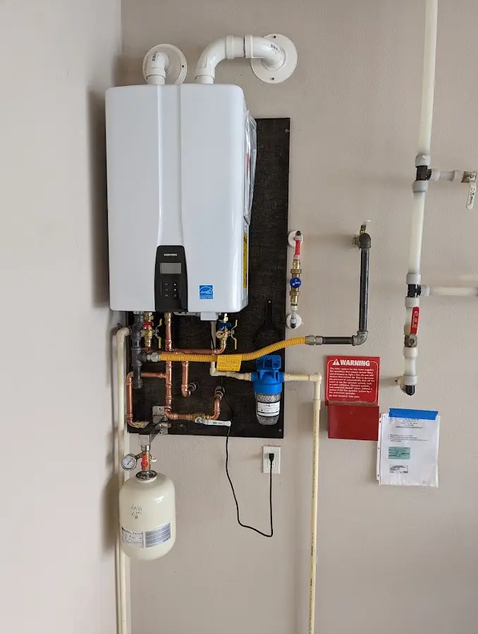 Professional plumber installing copper piping in a Channahon home